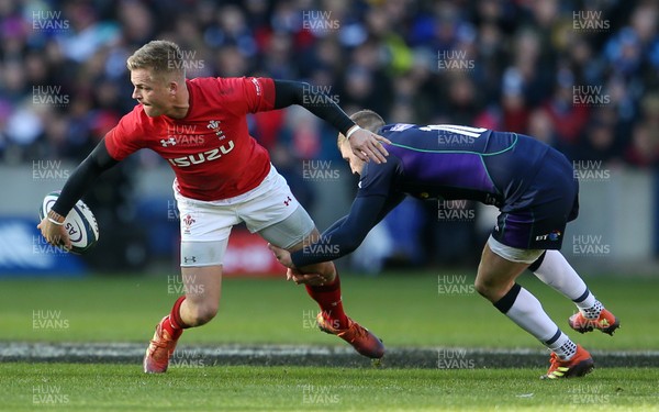 090319 - Scotland v Wales - Guinness 6 Nations - Gareth Anscombe of Wales is tackled by Finn Russell of Scotland