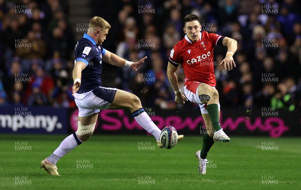 110223 - Scotland v Wales - Guinness 6 Nations Championship - Josh Adams of Wales kicks the ball past Kyle Steyn of Scotland 