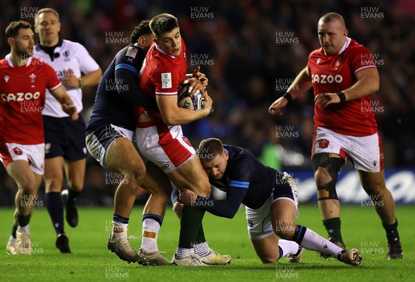 110223 - Scotland v Wales - Guinness 6 Nations Championship - Joe Hawkins of Wales is tackled by Sione Tuipulotu and Finn Russell of Scotland