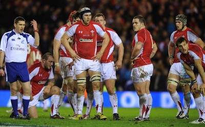 12.02.11 - Scotland v Wales - RBS Six Nations 2011 - Ryan Jones of Wales and his team mates look on with referee George Clancy. 
