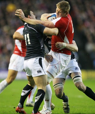 12.02.11 - Scotland v Wales... Wales Bradley Davies is tackled by Max Evans. 