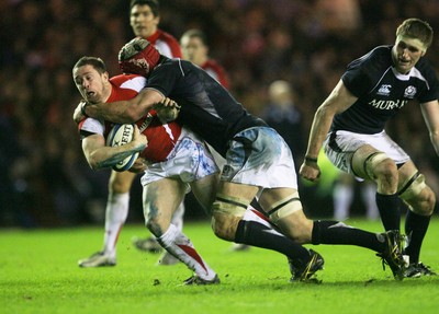 12.02.11 - Scotland v Wales... Wales  Shane Williams is tackled by Nathan Hines .. 