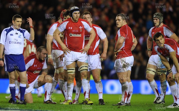 12.02.11 - Scotland v Wales - RBS Six Nations 2011 - Ryan Jones of Wales and his team mates look on with referee George Clancy. 