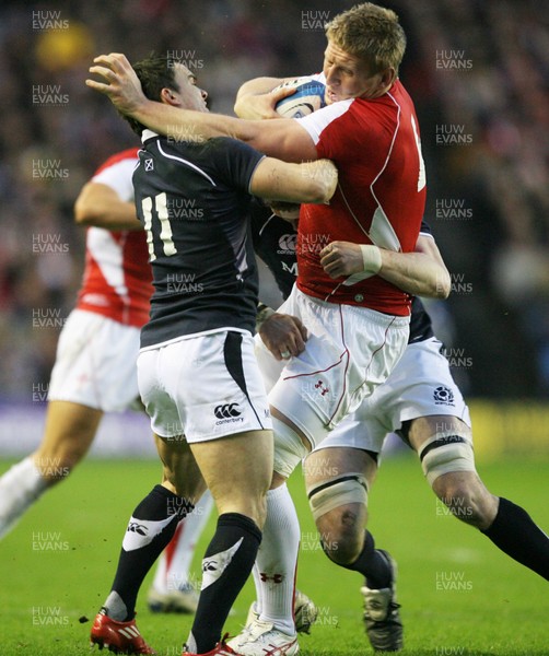 12.02.11 - Scotland v Wales... Wales Bradley Davies is tackled by Max Evans. 