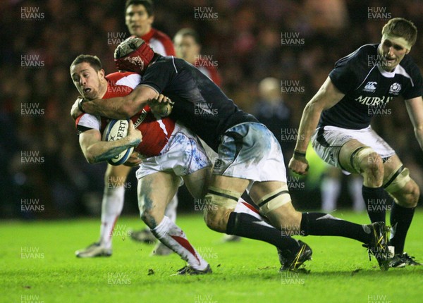 12.02.11 - Scotland v Wales... Wales  Shane Williams is tackled by Nathan Hines .. 