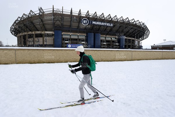 130221 - Scotland v Wales - Guinness 6 Nations - A women skis past Murrayfield Stadium in the snow