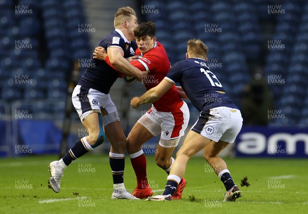 130221 - Scotland v Wales - Guinness 6 Nations - Louis Rees-Zammit of Wales is tackled by Duhan van der Merwe and Chris Harris of Scotland