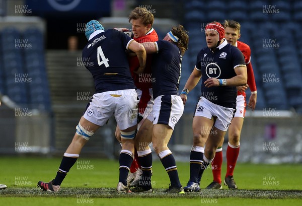 130221 - Scotland v Wales - Guinness 6 Nations - Nick Tompkins of Wales is tackled by Scott Cummings and Hamish Watson of Scotland