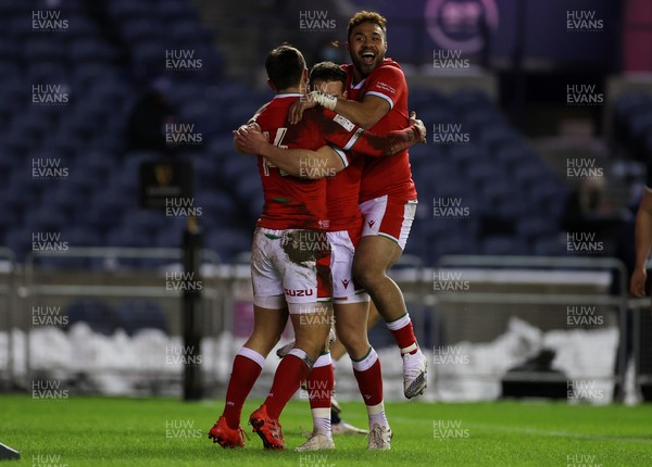 130221 - Scotland v Wales - Guinness 6 Nations - Louis Rees-Zammit of Wales celebrates scoring a try with Kieran Hardy and Willis Halaholo of Wales