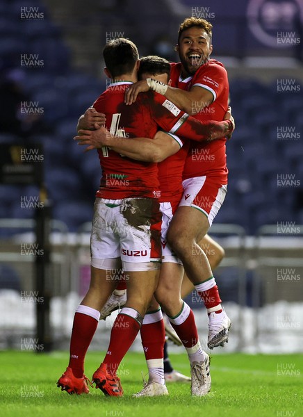 130221 - Scotland v Wales - Guinness 6 Nations - Louis Rees-Zammit of Wales celebrates scoring a try with Kieran Hardy and Willis Halaholo of Wales