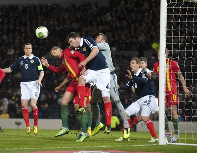 220313 -  Scotland v Wales - 2014 FIFA World Cup Qualifier -  Hampden Park - Scotland - Allan McGregor of Scotland clears the ball off the head of Jack Collison of Wales and Grant Hanley of Scotland 