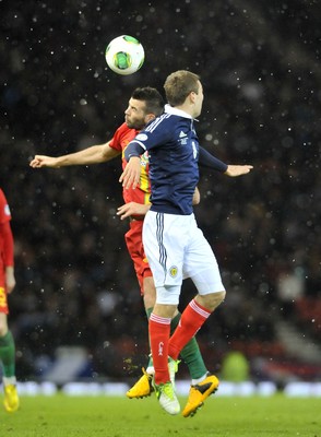 220313 -  Scotland v Wales - 2014 FIFA World Cup Qualifier -  Hampden Park - Scotland - Joe Ledley of Wales, left, beats James McArthur of Scotland in the air 