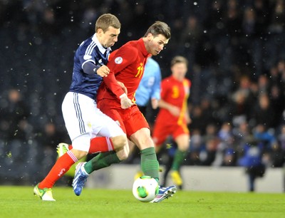 220313 -  Scotland v Wales - 2014 FIFA World Cup Qualifier -  Hampden Park - Scotland - Gareth Bale of Wales is tackled by James McArthur of Scotland 