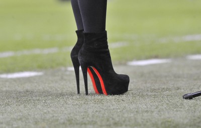 220313 -  Scotland v Wales - 2014 FIFA World Cup Qualifier -  Hampden Park - Scotland - Singer Amy MacDonald teeters on the side of the pitch in very high heels as she sings the National Anthem of Scotland 