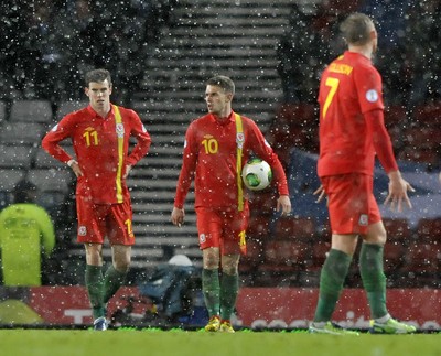 220313 -  Scotland v Wales - 2014 FIFA World Cup Qualifier -  Hampden Park - Scotland - Gareth Bale of Wales and Aaron Ramsey of Wales look dejected after Scotland take the lead 