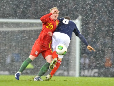 220313 -  Scotland v Wales - 2014 FIFA World Cup Qualifier -  Hampden Park - Scotland - Jonathan Williams of Wales is tackled by James McArthur of Scotland 