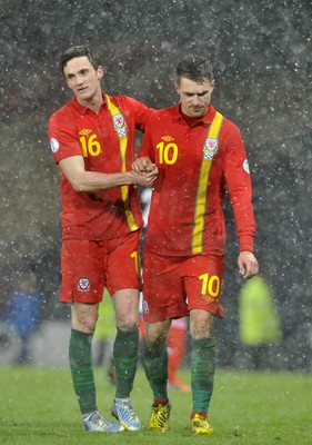 220313 -  Scotland v Wales - 2014 FIFA World Cup Qualifier -  Hampden Park - Scotland - A dejected Aaron Ramsey of Wales, right, is comforted by Andy King of Wales