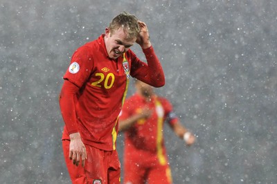220313 -  Scotland v Wales - 2014 FIFA World Cup Qualifier -  Hampden Park - Scotland - Jonathan Williams of Wales feels his head after a nasty collision 