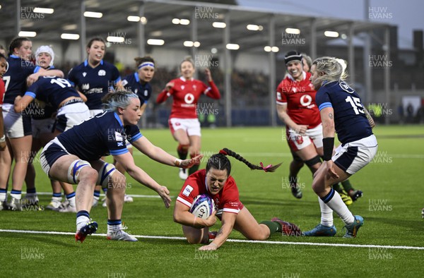 010423 - Scotland v Wales - TikTok Women's Six Nations - Ffion Lewis of Wales scores the last try of the game to secure victory for Wales despite Evie Gallagher of Scotland and Chloe Rollie of Scotland
