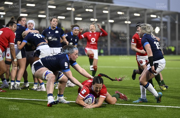 010423 - Scotland v Wales - TikTok Women's Six Nations - Ffion Lewis of Wales scores the last try of the game to secure victory for Wales despite Evie Gallagher of Scotland and Chloe Rollie of Scotland