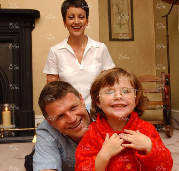 26.09.01 Welsh Edition story Brendon Williams  Welsh rugby player Scott Gibbs at home with his wife Sharyn and daughter Olivia who tries on his glasses.  