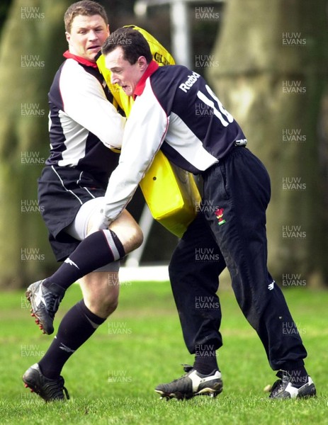 13-03-01. Rob Howley is tackled by Scott Gibbs during training. 