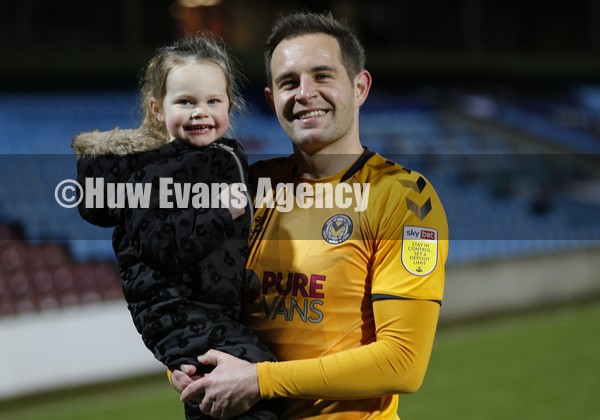 220122 - Scunthorpe United v Newport County - Sky Bet League 2 - Matty Dolan of Newport County cuddles his daughter Bella (3) at the end of the match