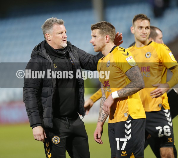 220122 - Scunthorpe United v Newport County - Sky Bet League 2 - Manager James Rowberry of Newport County with Scot Bennett of Newport County at the end of the match