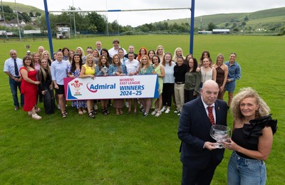 070625 - Senghenydd RFC Sirens - Senghenydd Sirens captain Shirey Webley receives the trophy from WRU representative Roy Wilkinson as the team celebrate winning the Admiral Women’s East League Title