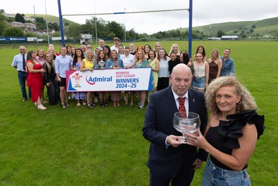 070625 - Senghenydd RFC Sirens - Senghenydd Sirens captain Shirey Webley receives the trophy from WRU representative Roy Wilkinson as the team celebrate winning the Admiral Women’s East League Title