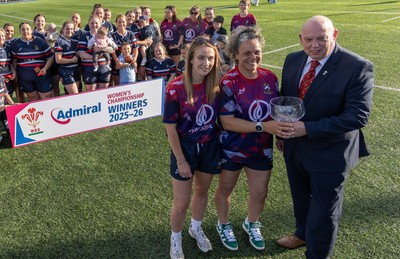 310526 - Senghenydd Sirens Admiral Womens Championship Presentation - Roy Wilkinson, WRU National Council Member presents Senghenydd Sirens co-captains, Holly Dempsey and Raf Taylor with the trophy after Sirens win the Admiral Women's National League Championship 