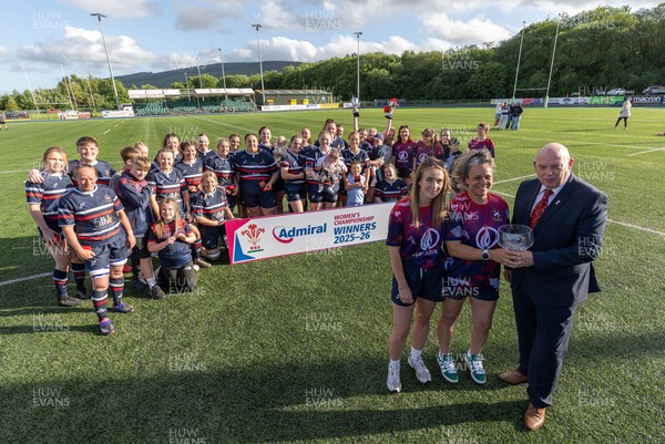 310526 - Senghenydd Sirens Admiral Womens Championship Presentation - Roy Wilkinson, WRU National Council Member presents Senghenydd Sirens co-captains, Holly Dempsey and Raf Taylor with the trophy after Sirens win the Admiral Women's National League Championship 