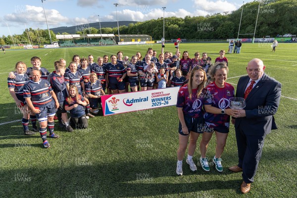 310526 - Senghenydd Sirens Admiral Womens Championship Presentation - Roy Wilkinson, WRU National Council Member presents Senghenydd Sirens co-captains, Holly Dempsey and Raf Taylor with the trophy after Sirens win the Admiral Women's National League Championship 
