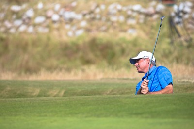 250714 -  The Senior Open Championship, Royal Porthcawl Golf Club, Wales - Fred Couples plays out of a bunker on the 9th