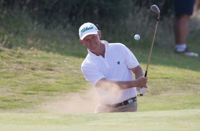 250714 -  The Senior Open Championship, Royal Porthcawl Golf Club, Wales - Jamie Spence of England plays out of the sand onto the 13th green