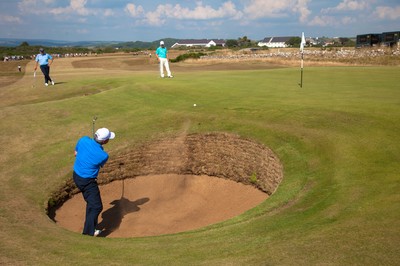 250714 -  The Senior Open Championship, Royal Porthcawl Golf Club, Wales - Fred Couples of the USA plays out of the bunker onto the 9th green