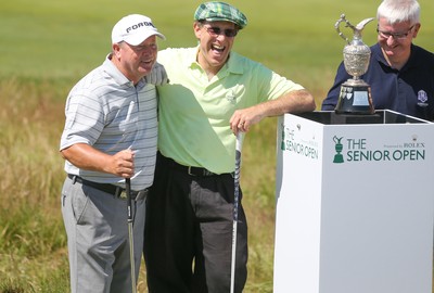 220714 -  The Senior Open Pro Am Competition, Royal Porthcawl Golf Club, Wales - Henry Englehardt , Chief Executive of  Admiral Insurance Group shares a joke with his professional partner Ian Woosnam before the start of their match 