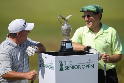 220714 -  The Senior Open Pro Am Competition, Royal Porthcawl Golf Club, Wales - Henry Englehardt , Chief Executive of  Admiral Insurance Group shares a joke with his professional partner Ian Woosnam before the start of their match 