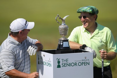 220714 -  The Senior Open Pro Am Competition, Royal Porthcawl Golf Club, Wales - Henry Englehardt , Chief Executive of  Admiral Insurance Group shares a joke with his professional partner Ian Woosnam before the start of their match 