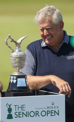 220714 -  The Senior Open Pro Am Competition, Royal Porthcawl Golf Club, Wales - Colin Montgomerie takes a closer look at the Senior Open Trophy at the start of the Pro Am Tournament 