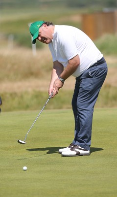 220714 -  The Senior Open Pro Am Competition, Royal Porthcawl Golf Club, Wales - Opera star Bryn Terfel putts during the Pro Am Tournament played ahead of the start of the Senior Open 2014 