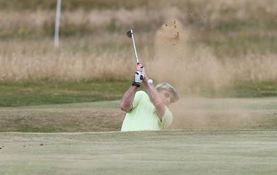 220714 -  The Senior Open Pro Am Competition, Royal Porthcawl Golf Club, Wales - Henry Englehardt, Chief Executive of Admiral Insurance Group tries to play out of a bunker during the Pro Am Tournament played ahead of the start of the Senior Open 2014 