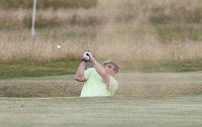 220714 -  The Senior Open Pro Am Competition, Royal Porthcawl Golf Club, Wales - Henry Englehardt, Chief Executive of Admiral Insurance Group tries to play out of a bunker during the Pro Am Tournament played ahead of the start of the Senior Open 2014 