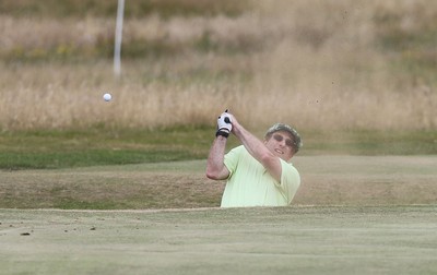 220714 -  The Senior Open Pro Am Competition, Royal Porthcawl Golf Club, Wales - Henry Englehardt, Chief Executive of Admiral Insurance Group tries to play out of a bunker during the Pro Am Tournament played ahead of the start of the Senior Open 2014 