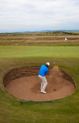 220714 -  The Senior Open Pro Am Competition, Royal Porthcawl Golf Club, Wales - Steve Jones of the USA plays out of a bunker during the Pro Am Tournament played ahead of the start of the Senior Open 2014 