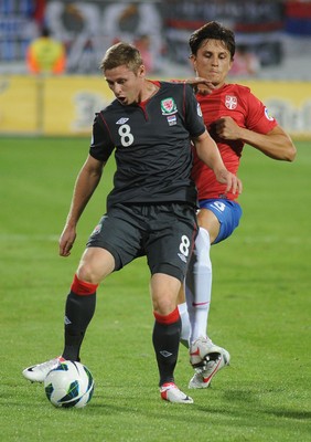 110912 - Serbia v Wales - 2014 World Cup Qualifier -Simon CHURCH of Wales and Ljubomir FEJSA of Serbia compete