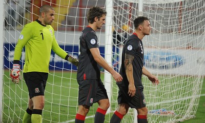 110912 - Serbia v Wales - 2014 World Cup Qualifier -Glyn Myhill, Sam Ricketts and Darcy Blake of Wales look dejected at the end of the game