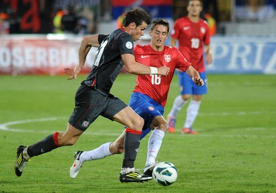 110912 - Serbia v Wales - 2014 World Cup Qualifier -Gareth Bale of Wales tries to get past Srdan MIJAILOVIC of Serbia