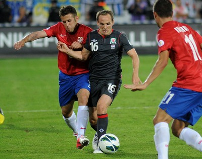 110912 - Serbia v Wales - 2014 World Cup Qualifier -David VAUGHAN of Wales and Miralem SULEJMANI of Serbia compete