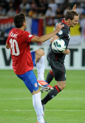 110912 - Serbia v Wales - 2014 World Cup Qualifier -David VAUGHAN of Wales and Dusan TADIC of Serbia compete